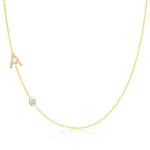 A Pavé Monogram Necklace with Diamond  and a letter A charm in yellow gold on a white background.