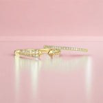 A Pavé Diamond Ring and Open Diamond Ring on a light pink background. 