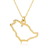 A Saudi Arabia pendant necklace in yellow gold with a diamond on a white background.
