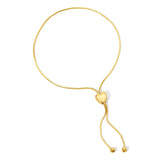 The Slide Heart Bracelet in yellow gold on a white background. 