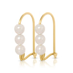 A pair of Tres Pearl Earrings on a white background. 
