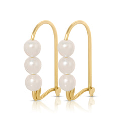 A pair of Tres Pearl Earrings on a white background. 