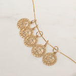 Five Libra Zodiac Pendants on The Slide Chain on an off-white background. 