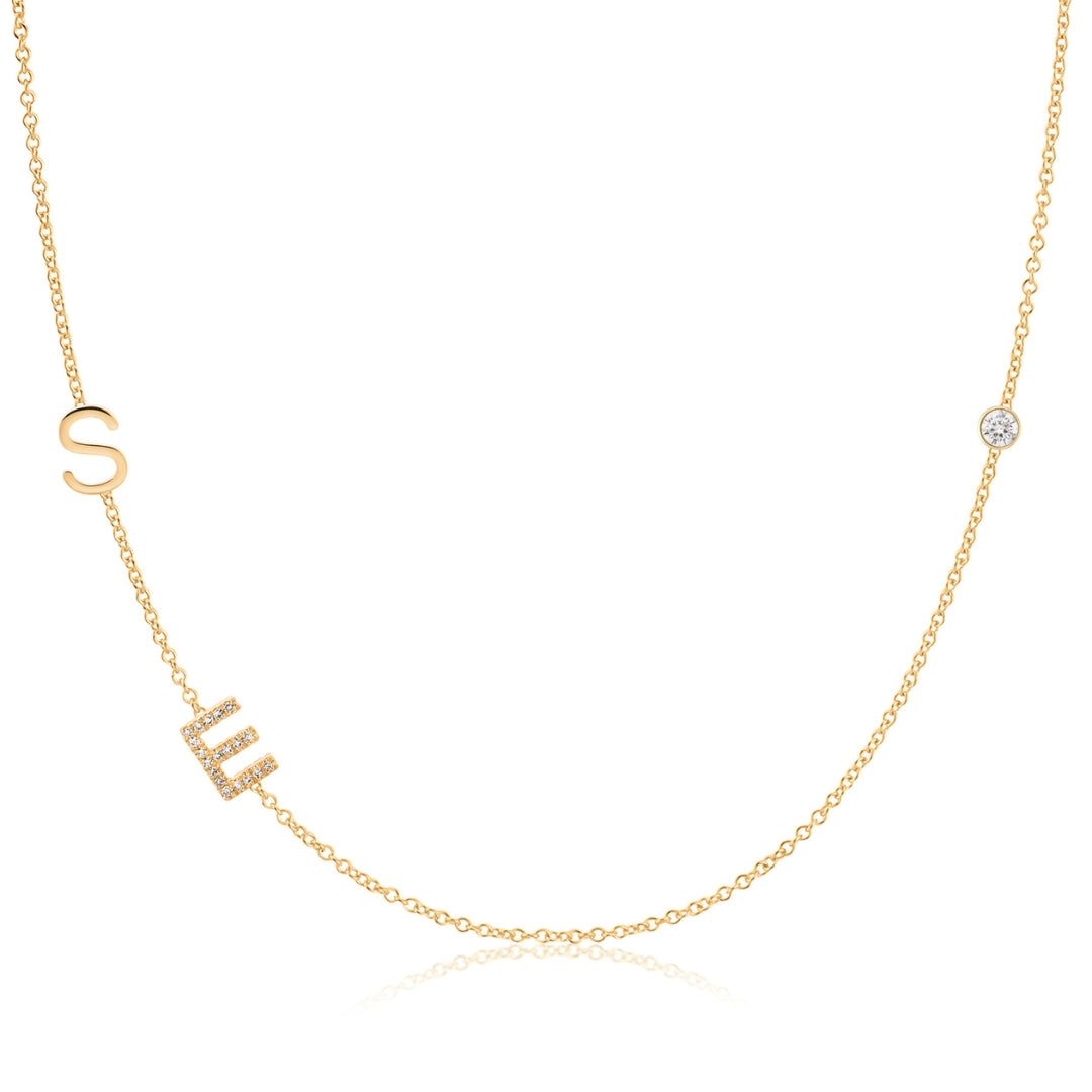 Gold necklace with 'SE' letters and a diamond on a white background