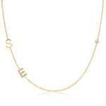 Gold necklace with 'SE' letters and a diamond on a white background
