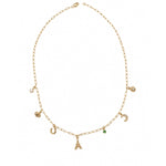 Gold necklace with various charms on a white background