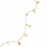 Gold chain bracelet with various charms on a white background