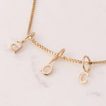 Gold necklace with letter pendants A B C 