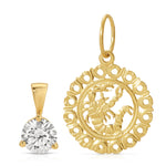 Gold pendant with intricate design and clear gemstone on a white background