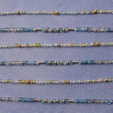 Six Endless Summer Bracelets in Saint-Tropez and Blue Lagoon laid horizontally against a light purple background. 