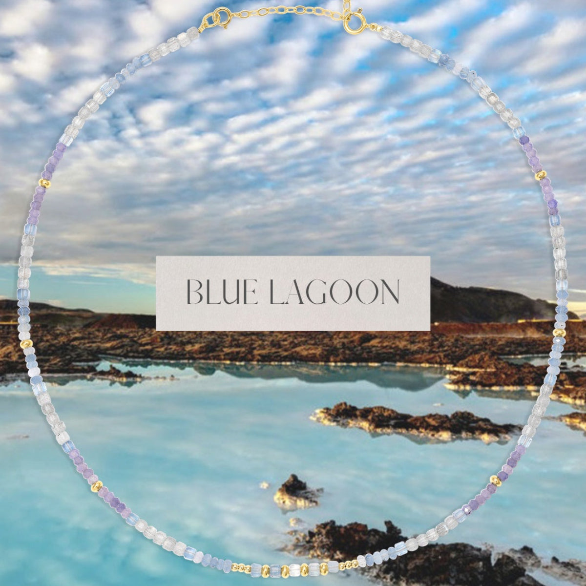An Endless Summer Necklace - Blue Lagoon over a scenic view of a lake and mountains, with the words "Blue Lagoon" in the centre. 