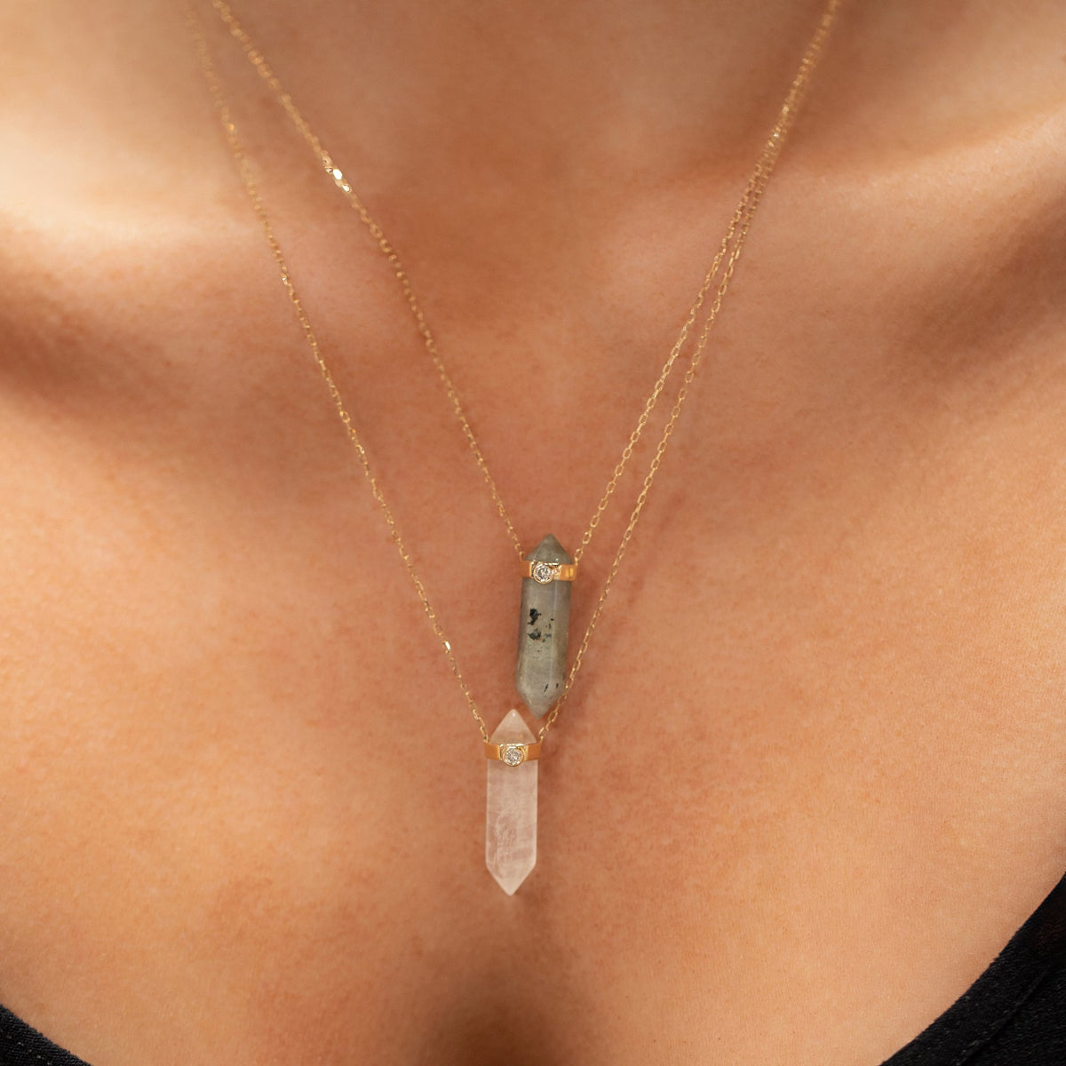 Close-up of a décolletage wearing two Retreat Necklaces in Protection and Clarity. 