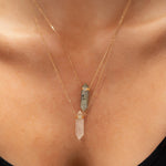 Close-up of a décolletage wearing two Retreat Necklaces in Protection and Clarity. 