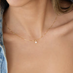 Close-up of a decellotage wearing a yellow gold Duchess Diamond Pendant with The Slide Chain. 