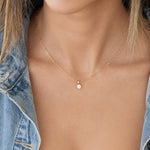 Close-up of a decellotage wearing an Element Short Link Chain with a Princess Diamond Pendant and a denim jacket. 