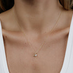 A woman's decellotage wearing a yellow gold Signature Cable Chain with a Gold Letter Jumble - A. 