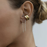 Close-up of an ear wearing two Down the Line Earrings and two yellow gold Ready to Mingle Ear Cuffs. 