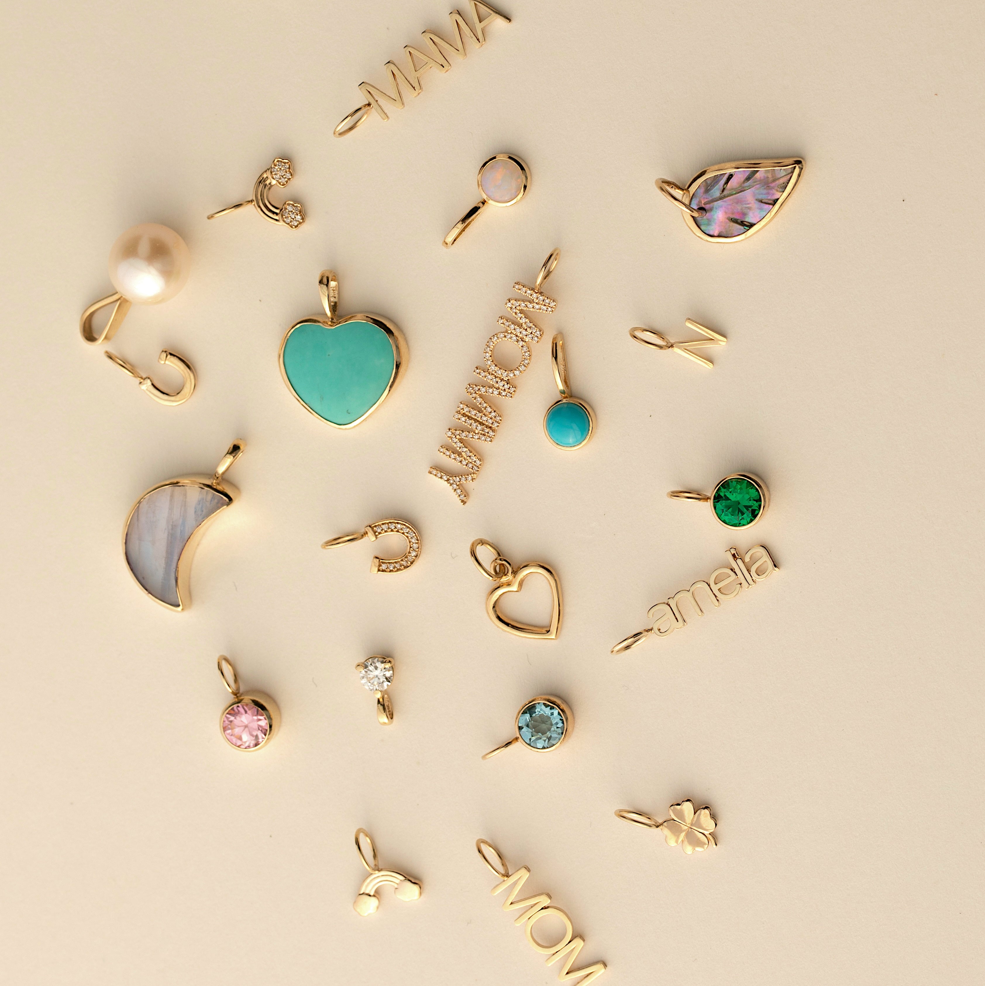 Collection of gold and colorful pendants on a beige background