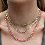 Close-up of a neck wearing layered Confetti Necklaces - green, yellow, blue and pink. 