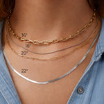 Gold and silver chain necklaces on a person's neck with measurements indicated.
