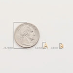 A silver coin with letter charms showing the measurements of each in millimetres. 