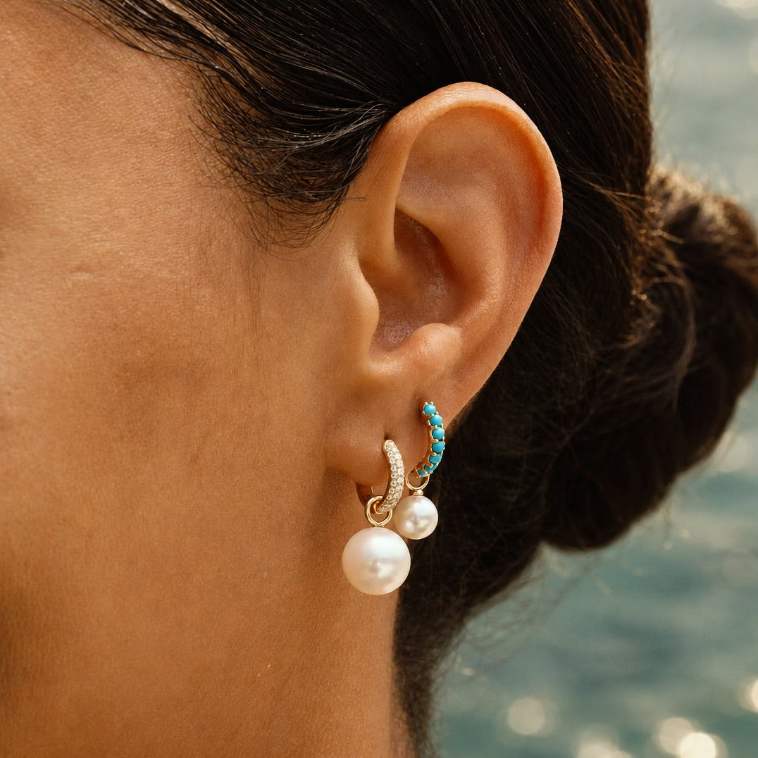 Model wearing the Pavé Huggie with a Maxi Pearl Earring Charm.