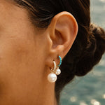 Model wearing the Pavé Huggie with a Maxi Pearl Earring Charm.