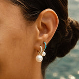 Model wearing the Pavé Huggie with a Maxi Pearl Earring Charm.