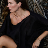 Model wearing the Lily Bouquet Bracelet layered with gold and diamond bracelets.