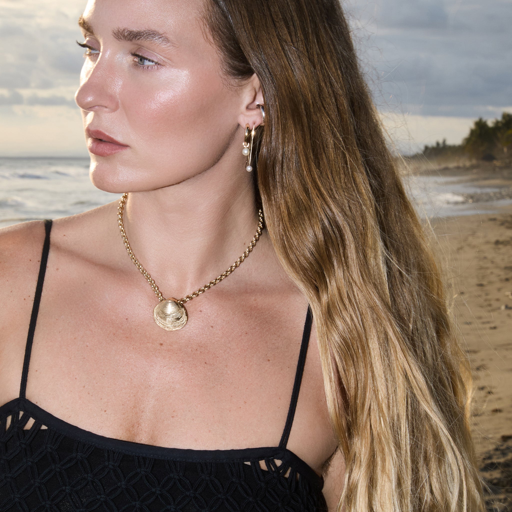 Model wearing the Maya Brenner Mini Pearl Ear Charm on Soleil Hoops with a pearl threader earring.