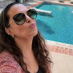 Maya Brenner wearing the Halo Pearl Ear Cuff styled in an ear stack, poolside selfie