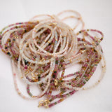 Multiple Endless Summer Necklaces in Pink Sands and Coral Reef intertwined against a white background. 