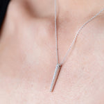 A close-up of a décolletage wearing a Love Struck Diamond Necklace in white gold. 