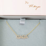 A Pavé GAGA Necklace in yellow gold with a cable chain in a Maya Brenner light grey and pink jewelry box. 