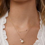 Monogram Necklace with Ruby Birthstone Layered with Pearl Pendant Necklace in Yellow Gold | Maya Brenner