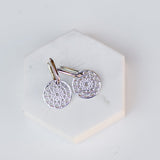 Skylight Hoops in sterling silver on a white stone surface. 