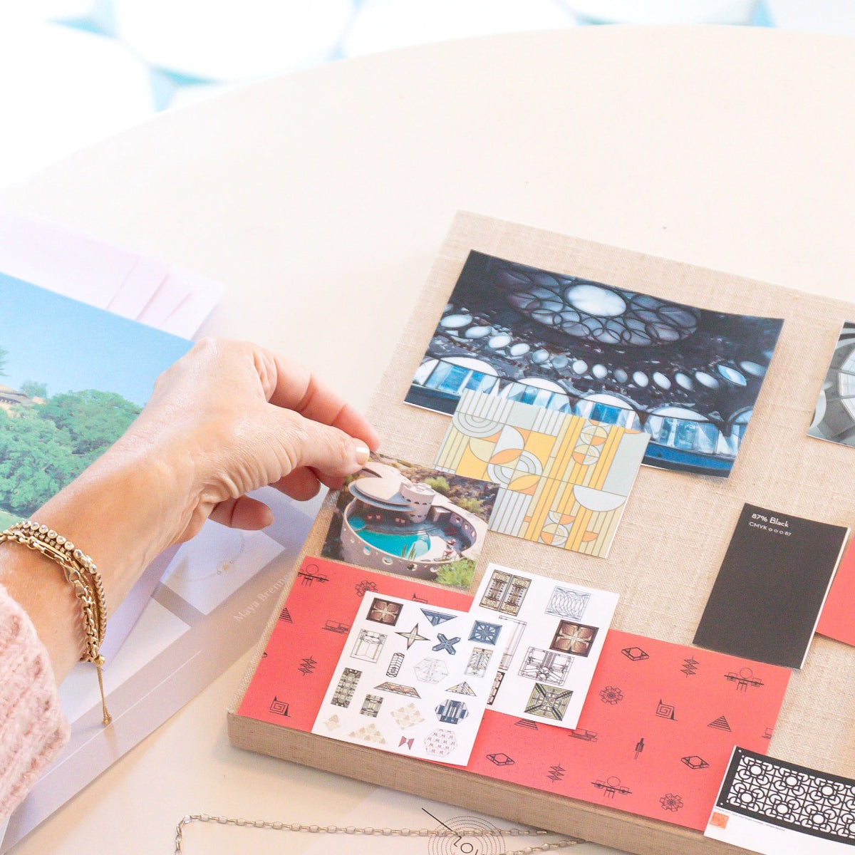 A person holding an image beside a collage of photographs, with her hand wearing a Love Set Match Bracelet, Down the Line Bracelet and a Rolo Bracelet against a light surface.