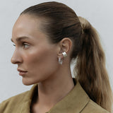 A Ready to Mingle Ear Cuff in sterling silver on a white background. 