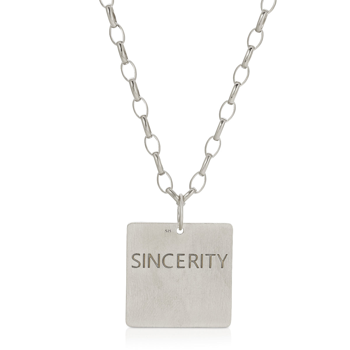 The back of a Virtues Pendant - Square in sterling silver with 'SINCERITY' engraved on a white background. 