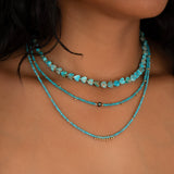 Close-up of a woman's neck wearing Endless Summer Necklaces in Santorini, Turqs + Caicos and Sea + Sky. 
