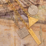 Four Virtues Pendants - Square and Circle in sterling silver, and Rectangle and Triangle in yellow gold vermeil on top of surface with different sketches. 