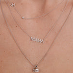 Silver 'MAMA' necklace on a person's neck with a close-up view.