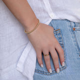 A hand wearing a Statement Bubble Bracelet, two Delicate Beaded Bands and a Twinkle Twinkle Ring, in a jean pocket with a white shirt.