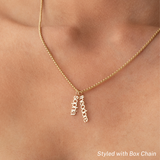 A close-up of a neck wearing a Box Chain with two Petite Nameplate Pendants, 'sophia' and 'theodore', all in yellow gold. 