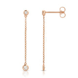 Droplet Diamond Earrings in rose gold on a white background. 