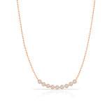 A Diamond Arc Layering Necklace in rose gold on a white background. 