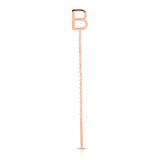 A rose gold threader earring with a letter B stud on a white background.