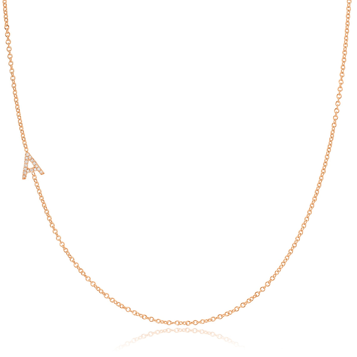 A rose gold necklace with a pave letter A charm on a white background. 