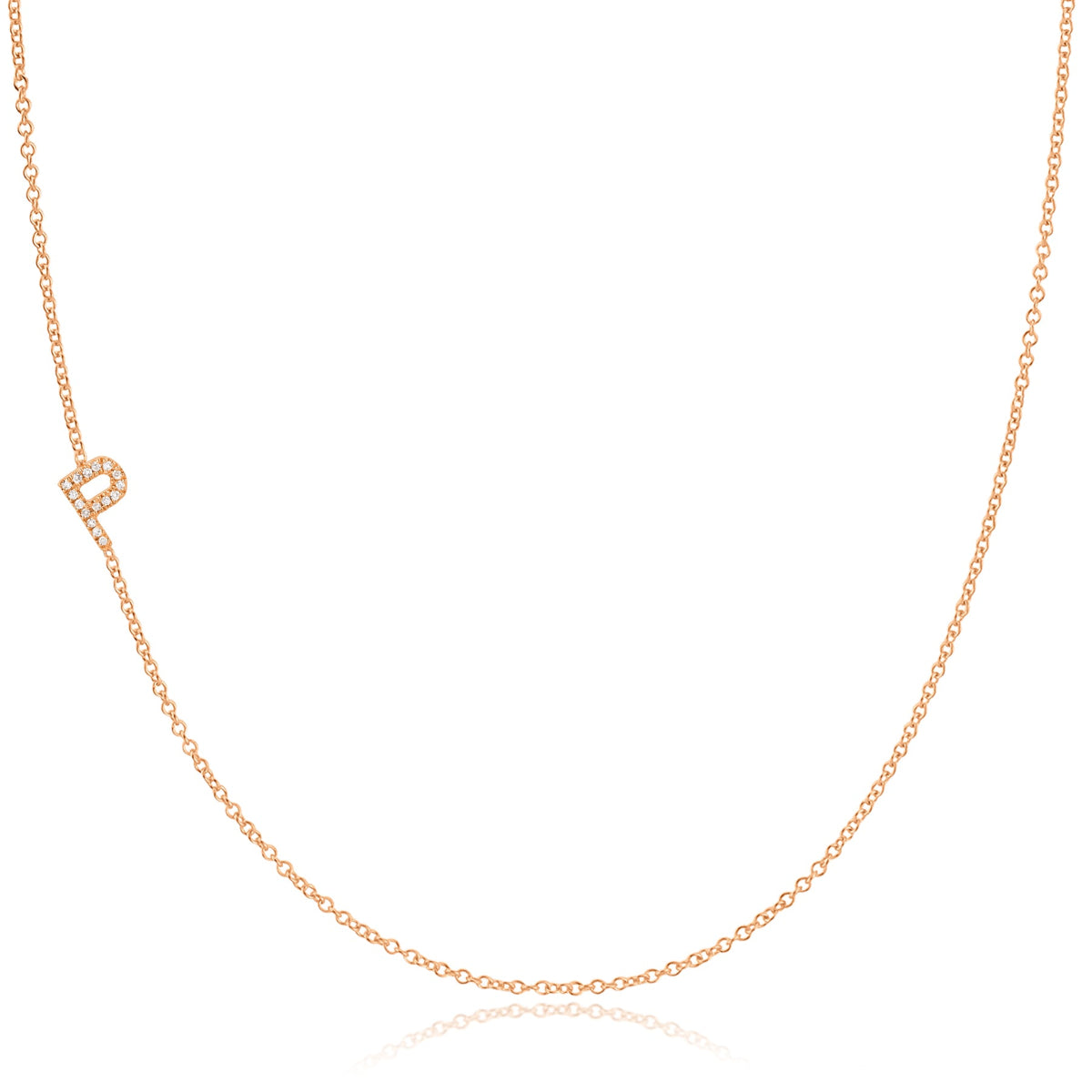 A rose gold necklace with a pave letter P charm on a white background. 