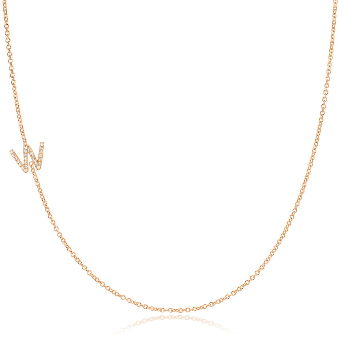 A rose gold necklace with a pave letter W charm on a white background. 